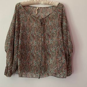 Fun top with dolman sleeves, a colorful feather print and front tie.